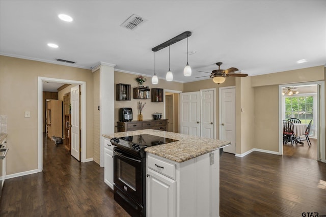kitchen featuring black range with electric cooktop, baseboards, visible vents, and white cabinets