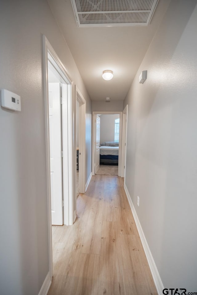 corridor with light wood-type flooring