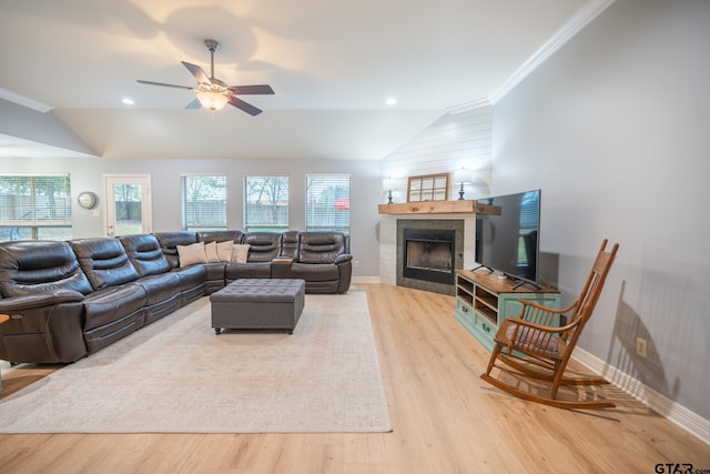 living room with light hardwood / wood-style flooring, crown molding, vaulted ceiling, and ceiling fan