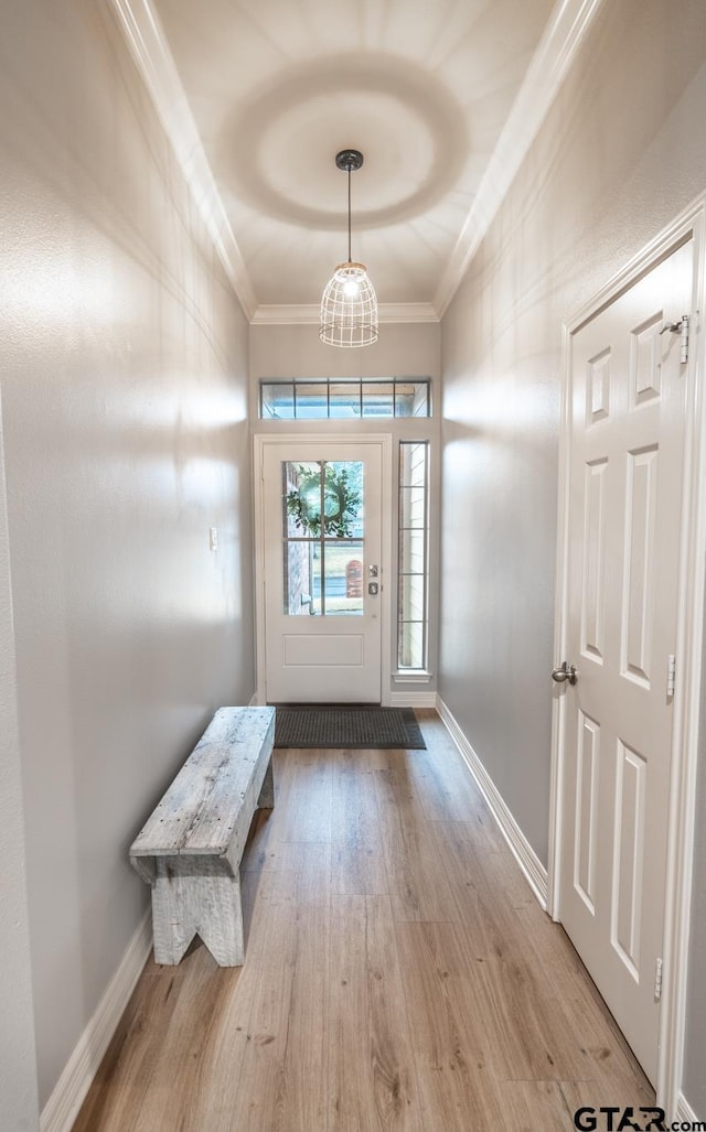 entryway featuring crown molding and light hardwood / wood-style flooring