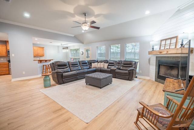 living room featuring ceiling fan, lofted ceiling, and light hardwood / wood-style floors