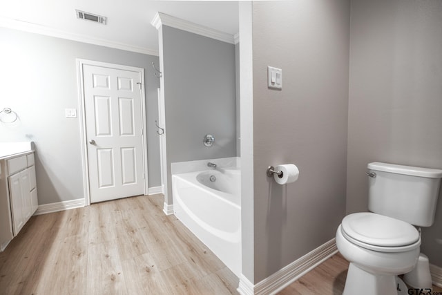 bathroom with toilet, crown molding, vanity, hardwood / wood-style flooring, and a washtub