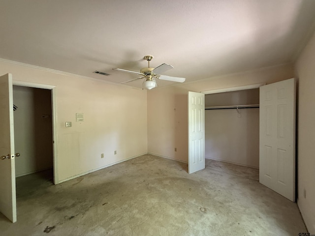 unfurnished bedroom featuring crown molding, a closet, ceiling fan, light colored carpet, and visible vents