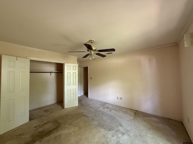 unfurnished bedroom featuring crown molding, a closet, ceiling fan, carpet flooring, and visible vents