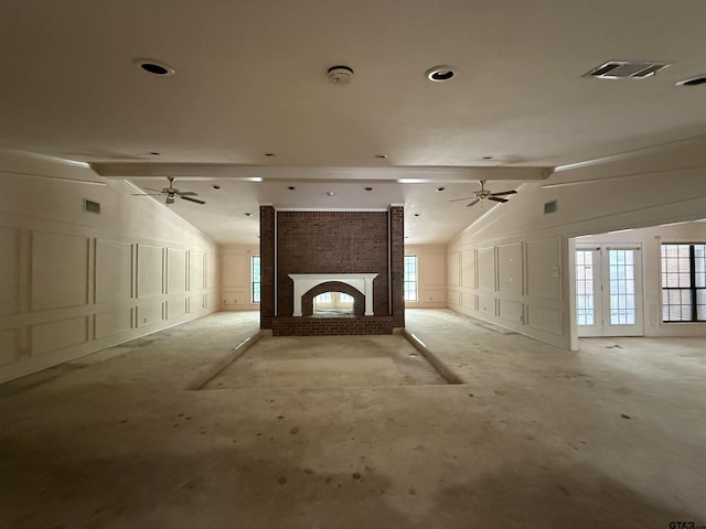 unfurnished living room with lofted ceiling with beams, visible vents, ceiling fan, and a decorative wall