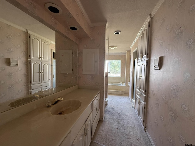 full bath featuring a textured ceiling, wallpapered walls, a bath, vanity, and ornamental molding