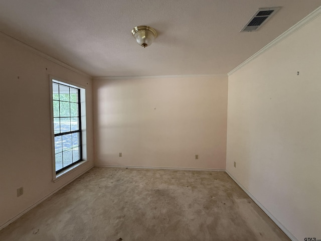 unfurnished room featuring baseboards, ornamental molding, and visible vents