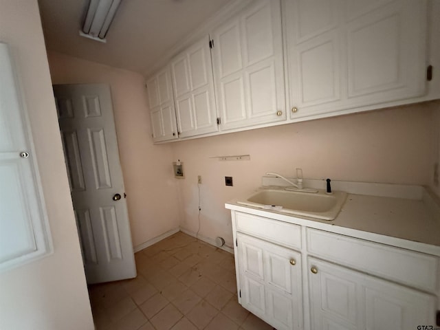 clothes washing area with hookup for a washing machine, baseboards, cabinet space, and a sink