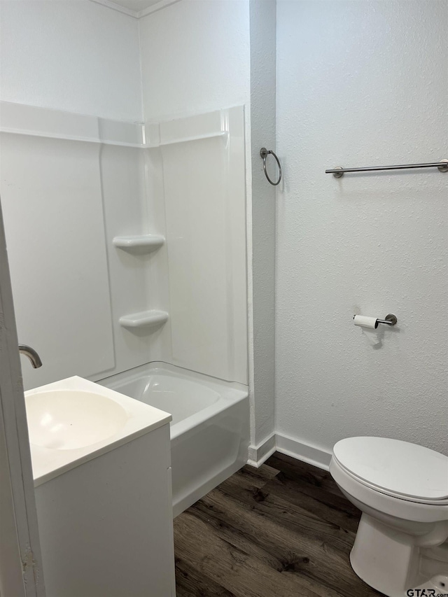 702 W Kilpatrick St, Mineola, TX 75773 - full bath with wood finished floors, tub / shower combination, and vanity