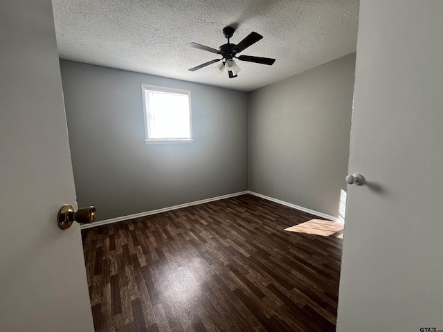 spare room with a textured ceiling, ceiling fan, wood finished floors, and baseboards