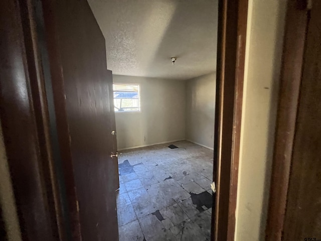 spare room featuring a textured ceiling