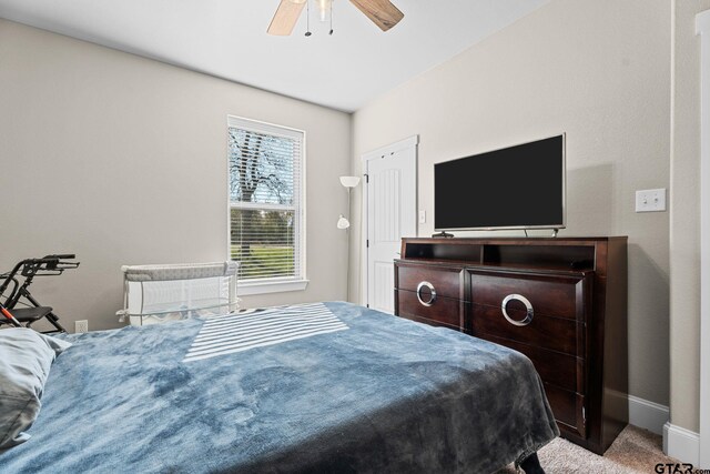 bedroom with baseboards, carpet floors, and ceiling fan