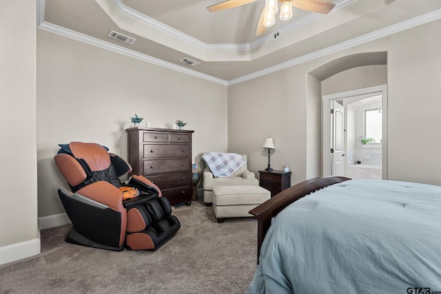 carpeted bedroom with visible vents, baseboards, a tray ceiling, and ornamental molding