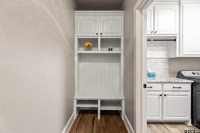 mudroom with baseboards, washer / dryer, and wood finished floors