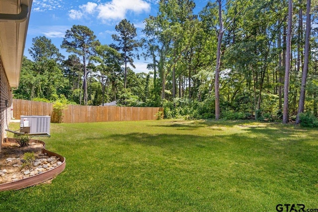 view of yard featuring cooling unit and fence