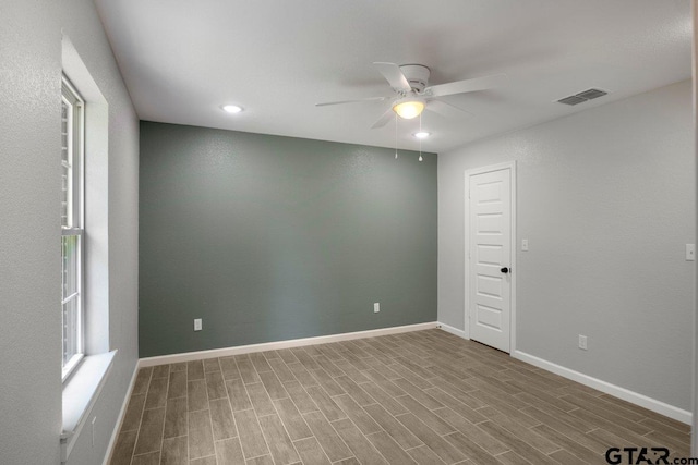 unfurnished room with wood finished floors, visible vents, baseboards, ceiling fan, and recessed lighting