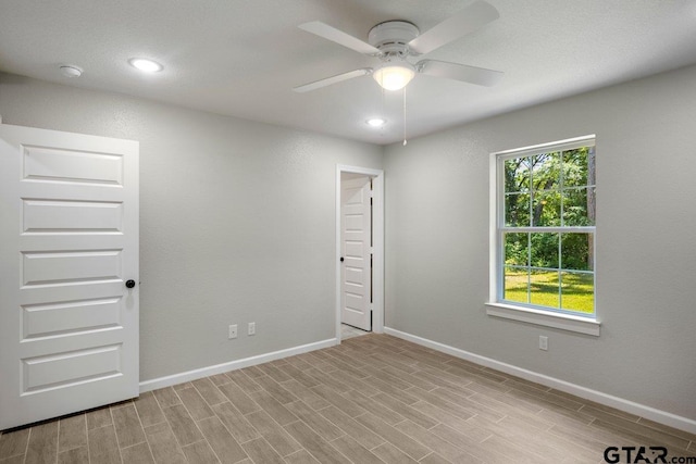 spare room with baseboards, recessed lighting, light wood-style floors, and ceiling fan