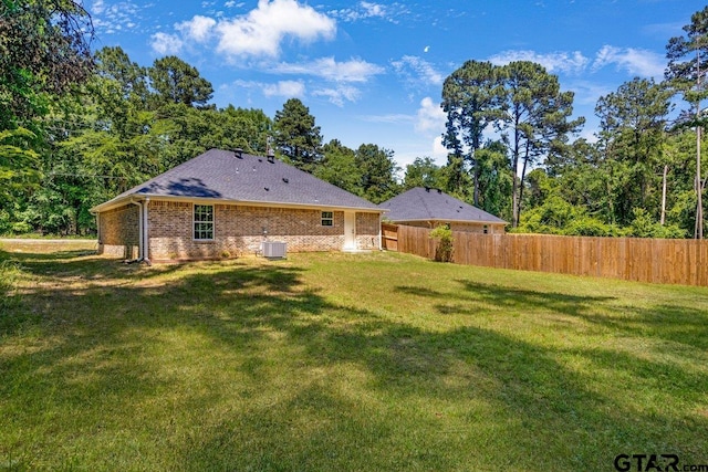view of yard with cooling unit and fence