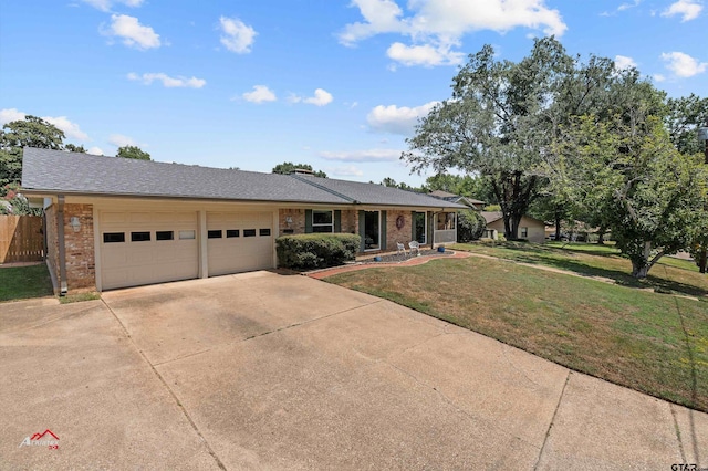 ranch-style house featuring a garage and a front yard