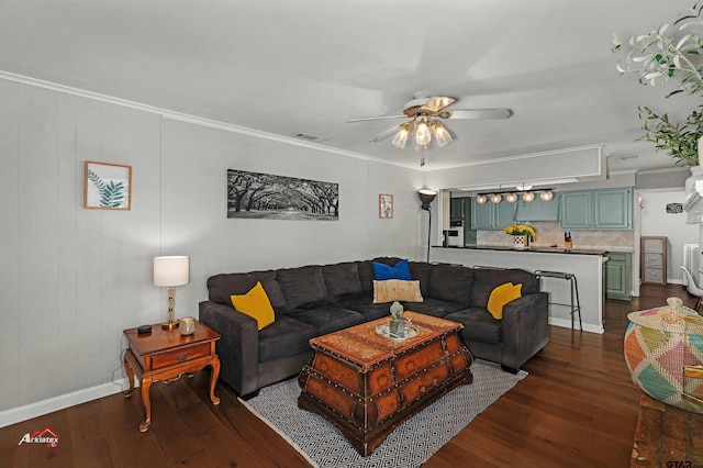 living room with crown molding, dark wood-type flooring, and ceiling fan