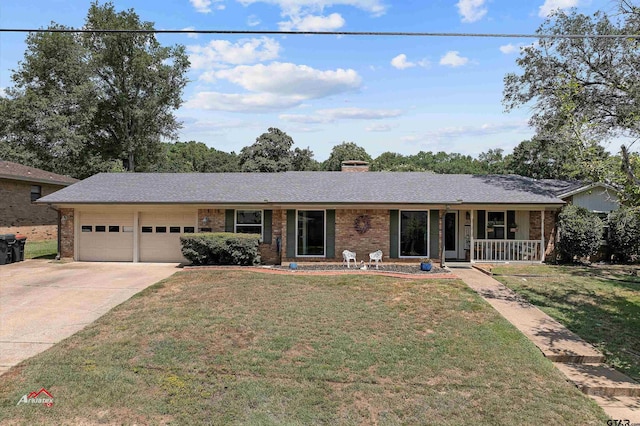 ranch-style house featuring a porch, a garage, and a front yard