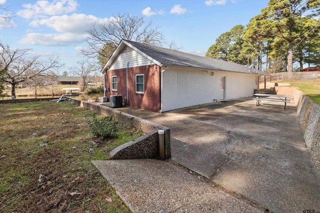 view of property exterior with central AC and a patio area