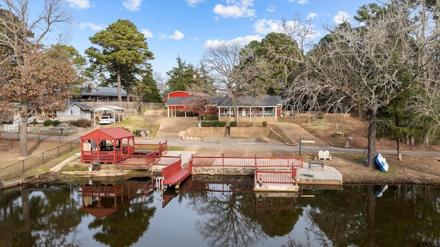 view of dock featuring a gazebo and a water view