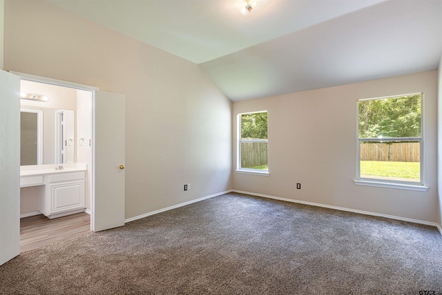 221 Maggie Cir, Flint, TX 75762 - unfurnished bedroom featuring carpet floors, vaulted ceiling, and ensuite bath