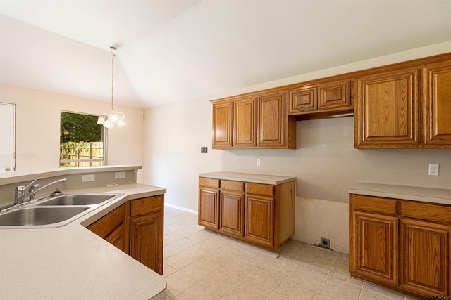221 Maggie Cir, Flint, TX 75762 - kitchen with brown cabinets, lofted ceiling, decorative light fixtures, and light countertops