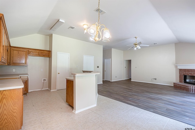 221 Maggie Cir, Flint, TX 75762 - kitchen featuring lofted ceiling, light countertops, a chandelier, light tile patterned floors, and brown cabinetry