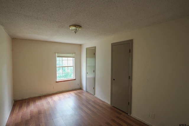 14832 Fm 2661, Flint, TX 75762 - spare room featuring wood finished floors and a textured ceiling