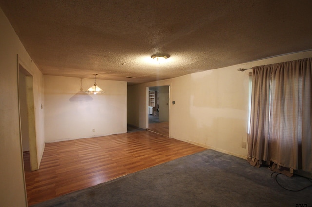 14832 Fm 2661, Flint, TX 75762 - spare room with a textured ceiling, wood finished floors, and baseboards