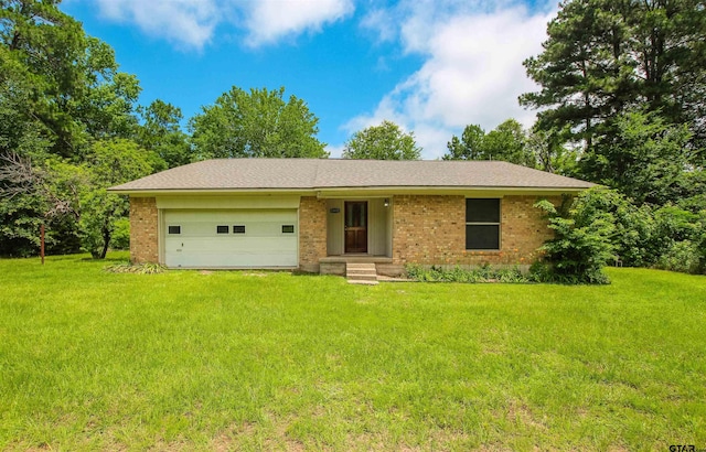 14832 Fm 2661, Flint, TX 75762 - ranch-style home with an attached garage, a front yard, brick siding, and driveway