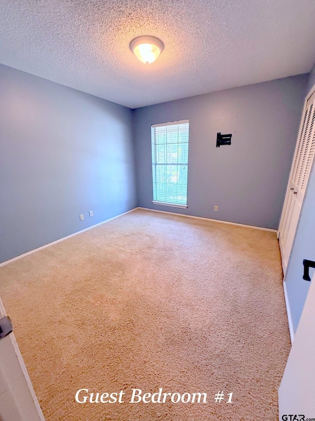 3900 S Donnybrook Ave, Tyler, TX 75703 - carpeted spare room with a textured ceiling and baseboards