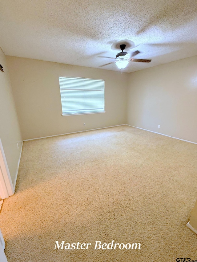 3900 S Donnybrook Ave, Tyler, TX 75703 - carpeted spare room featuring ceiling fan, baseboards, and a textured ceiling