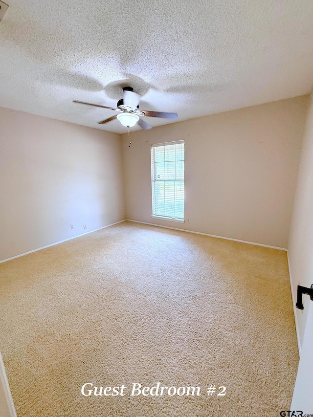 3900 S Donnybrook Ave, Tyler, TX 75703 - carpeted empty room with a ceiling fan, baseboards, and a textured ceiling