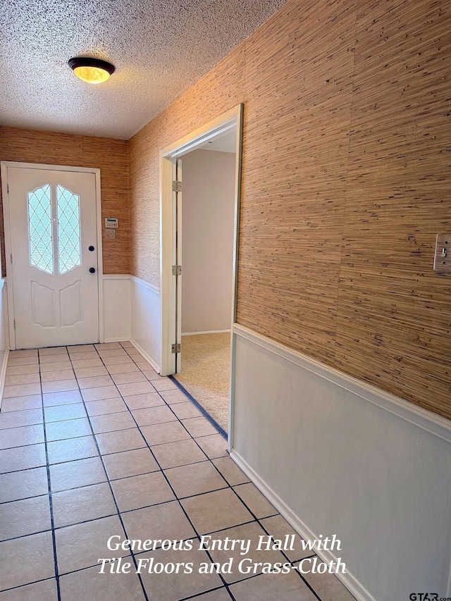 3900 S Donnybrook Ave, Tyler, TX 75703 - entryway with wainscoting, a textured ceiling, and light tile patterned floors
