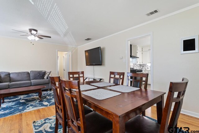 1135 E Sixth St, Tyler, TX 75701 - dining area featuring light wood-style flooring, a ceiling fan, and crown molding