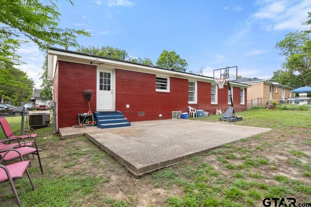 1135 E Sixth St, Tyler, TX 75701 - back of property featuring entry steps, brick siding, a fenced backyard, and a patio