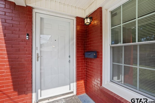 1135 E Sixth St, Tyler, TX 75701 - view of exterior entry with brick siding and a porch