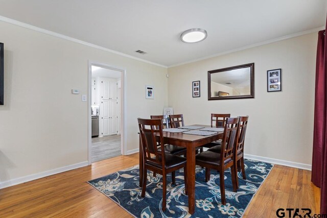 1135 E Sixth St, Tyler, TX 75701 - dining room featuring wood finished floors and ornamental molding