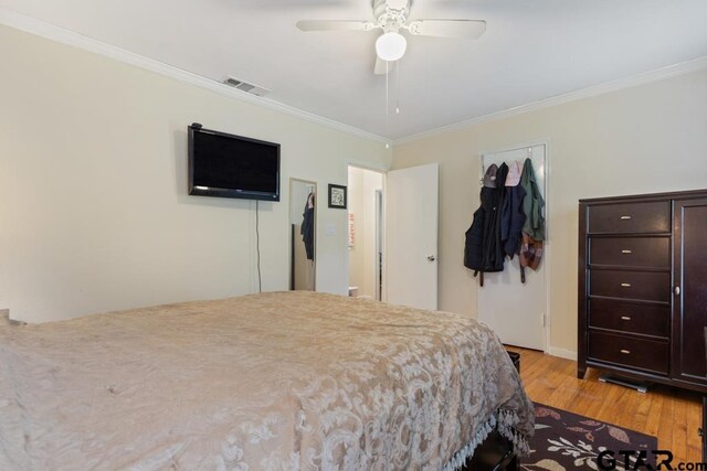 1135 E Sixth St, Tyler, TX 75701 - bedroom with ornamental molding, light wood finished floors, and ceiling fan