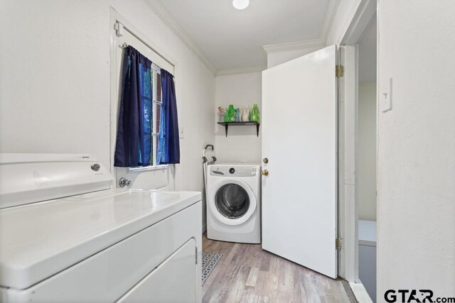 1135 E Sixth St, Tyler, TX 75701 - washroom with separate washer and dryer, crown molding, and light wood-type flooring