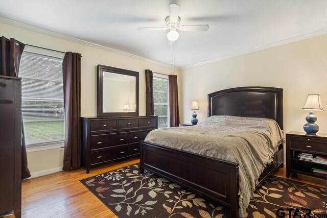 1135 E Sixth St, Tyler, TX 75701 - bedroom featuring crown molding, light wood-style floors, and a ceiling fan
