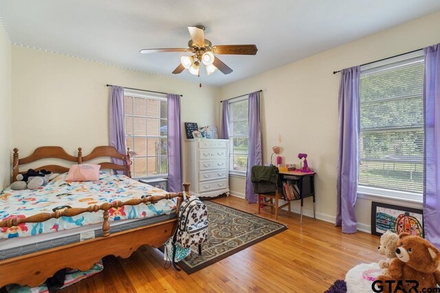 1135 E Sixth St, Tyler, TX 75701 - bedroom with wood finished floors and a ceiling fan