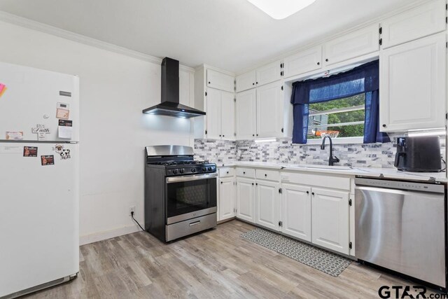 1135 E Sixth St, Tyler, TX 75701 - kitchen featuring stainless steel appliances, wall chimney exhaust hood, decorative backsplash, light countertops, and ornamental molding