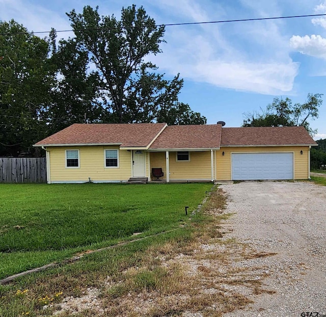 ranch-style house with a front yard and a garage