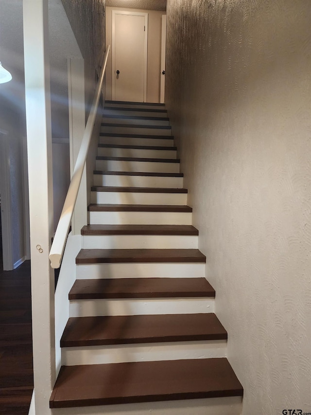 staircase with hardwood / wood-style flooring