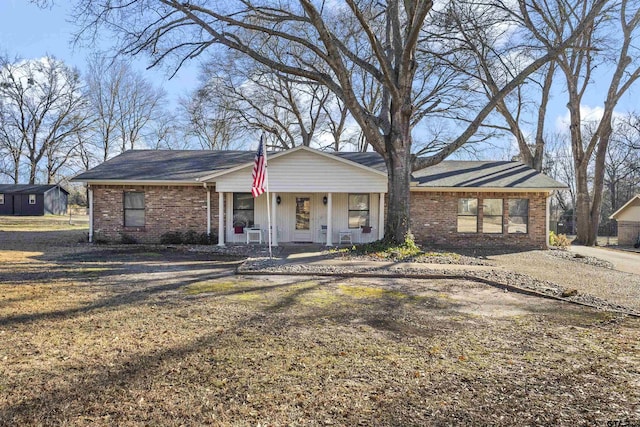 ranch-style house with a front lawn and a porch