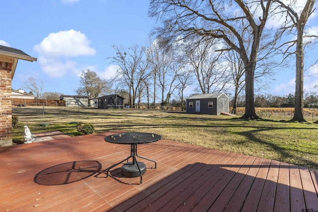 wooden deck featuring a yard and an outbuilding